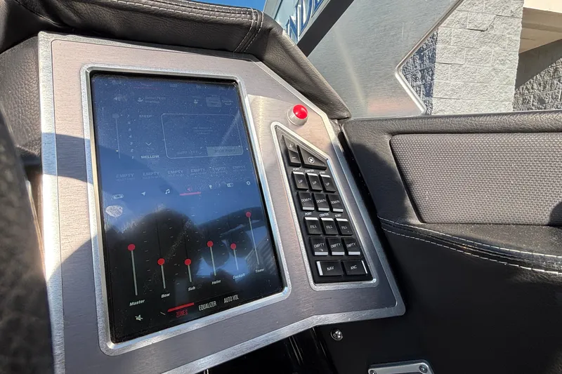 Slide: The Image of 2022 MasterCraft X26 boat dashboard with touchscreen controls and keypad. - 25