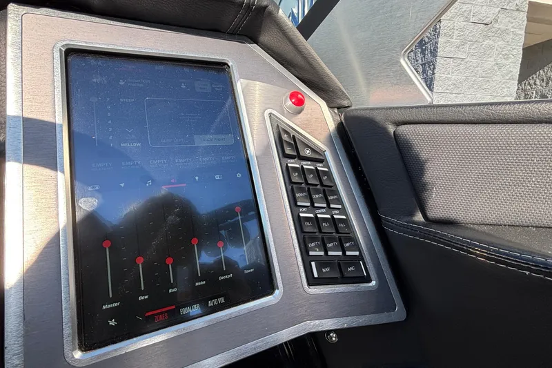 Slide: The Image of 2022 MasterCraft X26 boat control panel with touchscreen and buttons. - 26