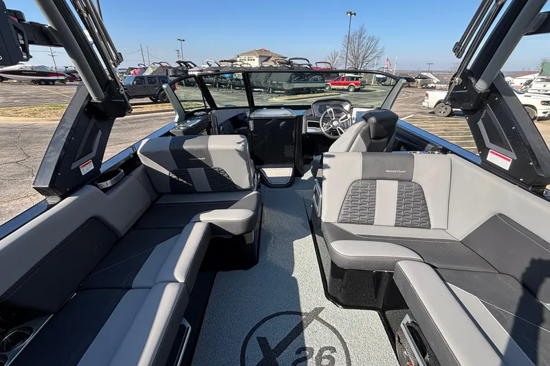 Slide: The Image of 2022 MasterCraft X26 boat interior with luxurious seating and modern dashboard. - 28