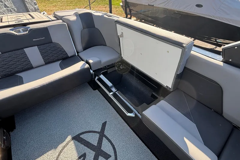 Slide: The Image of 2022 MasterCraft X26 boat interior with open storage compartment and stylish seating. - 30