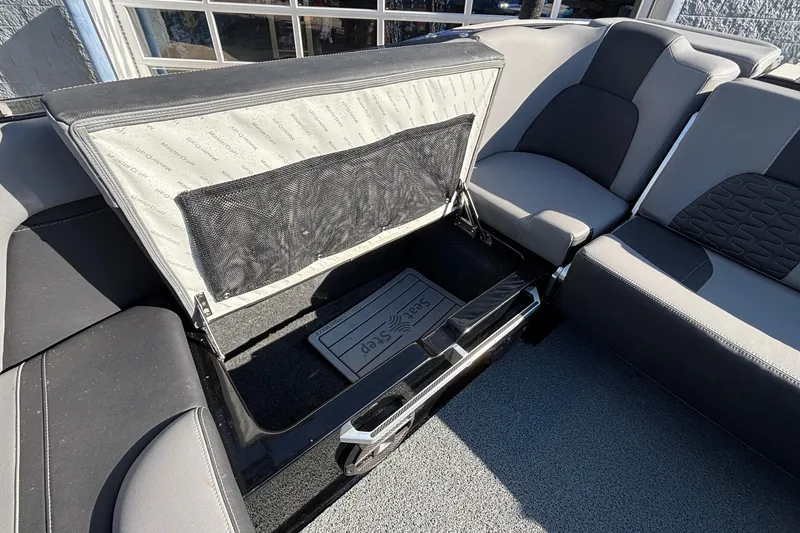 Slide: The Image of 2022 MasterCraft X26 boat interior with open storage compartment and seating. - 31