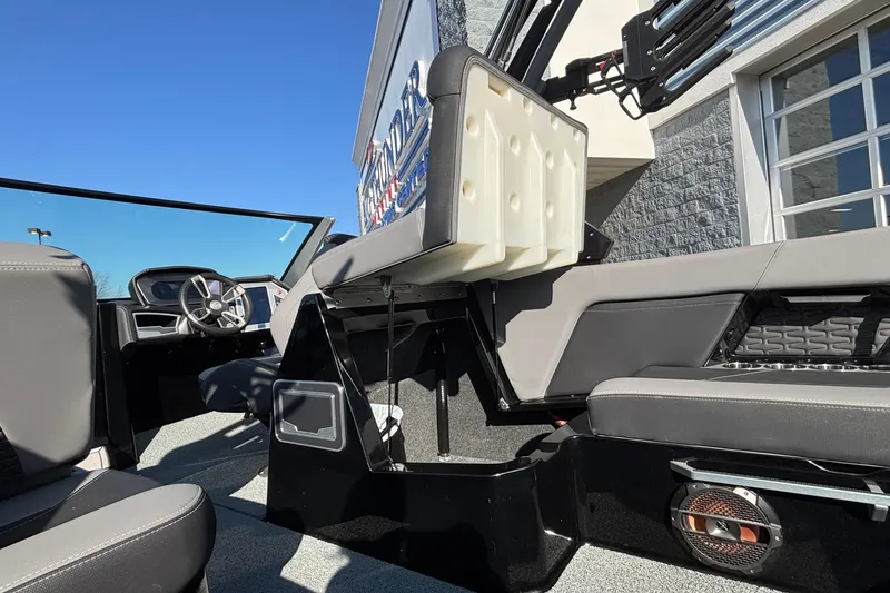 Slide: The Image of 2022 MasterCraft X26 boat interior with modern seating and steering wheel. - 32