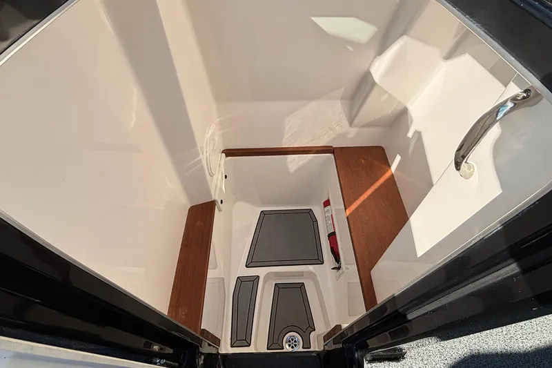 Slide: The Image of 2022 MasterCraft X26 interior cabin with wooden accents and safety equipment. - 46