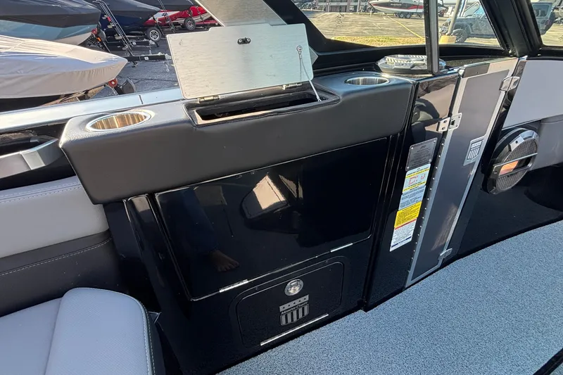 Slide: The Image of 2022 MasterCraft X26 boat interior with cup holders and storage compartments. - 47