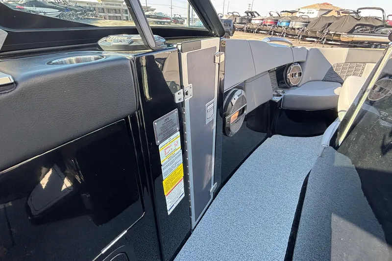 Slide: The Image of 2022 MasterCraft X26 boat interior with sleek seating and modern audio system. - 53