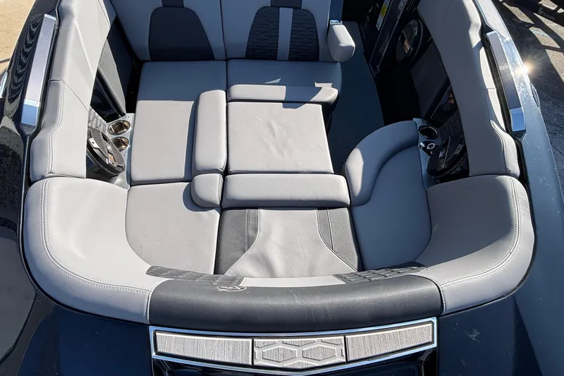 Slide: The Image of 2022 MasterCraft X26 boat interior with luxurious gray seating and cup holders. - 59