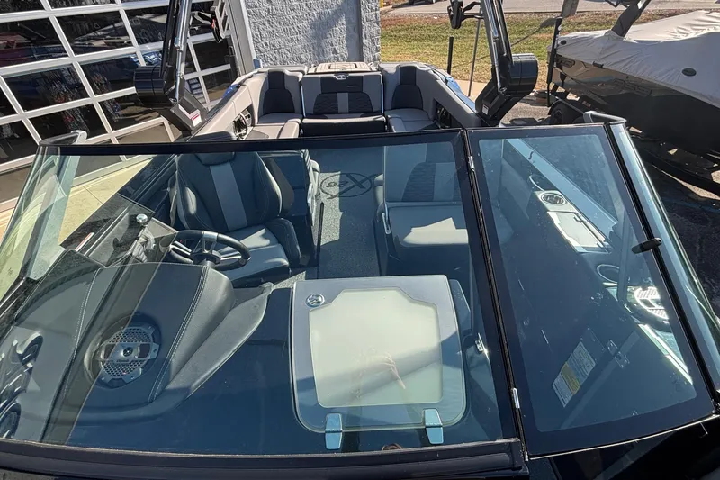 Slide: The Image of 2022 MasterCraft X26 boat interior with seating and steering wheel, viewed from above. - 65