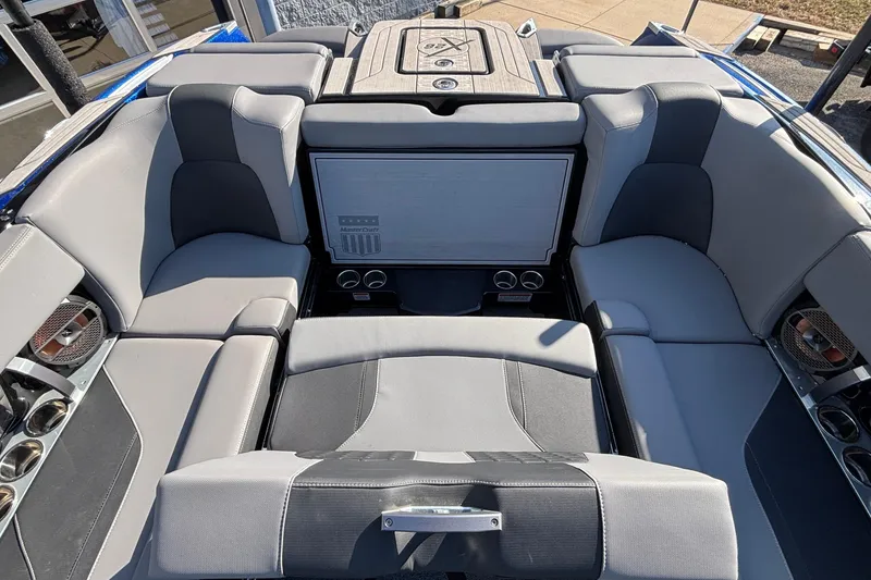 Slide: The Image of 2022 MasterCraft X26 boat interior with luxurious gray seating and cup holders. - 69