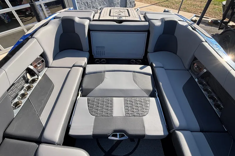 Slide: The Image of 2022 MasterCraft X26 boat interior with luxurious seating and cup holders. - 70