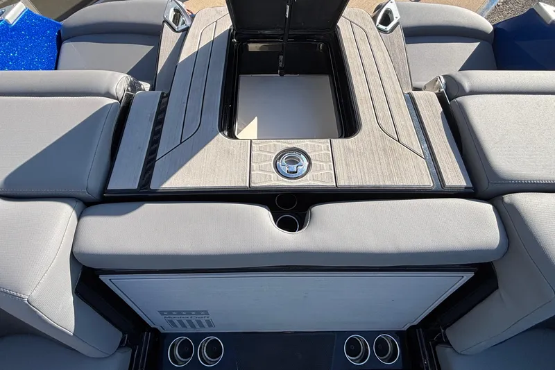Slide: The Image of 2022 MasterCraft X26 boat interior with sleek seating and storage compartment. - 72