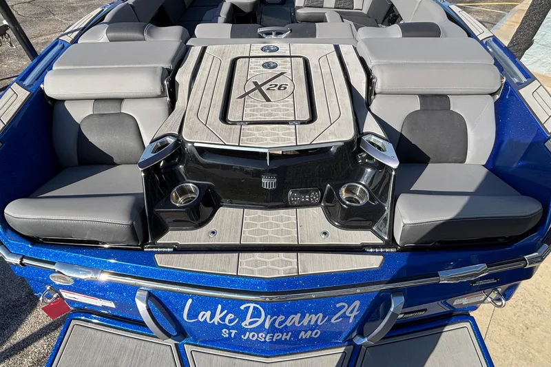 Slide: The Image of 2022 MasterCraft X26 boat interior with gray seating and custom deck design. - 8