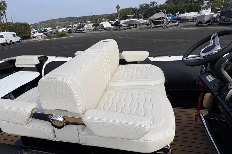 Slide: The Image of 2025 Williams Jet Tenders Dieseljet 445 with white seating at a marina. - 6