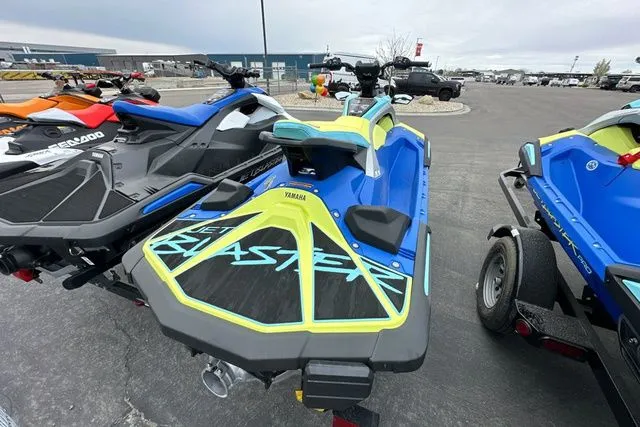 Slide: The Image of 2026 Yamaha WaveRunner JETBLASTER PRO in blue and yellow on a parking lot. - 4