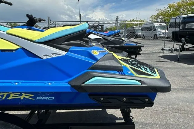 Slide: The Image of 2026 Yamaha WaveRunner JETBLASTER PRO in blue and yellow on parking lot. - 11