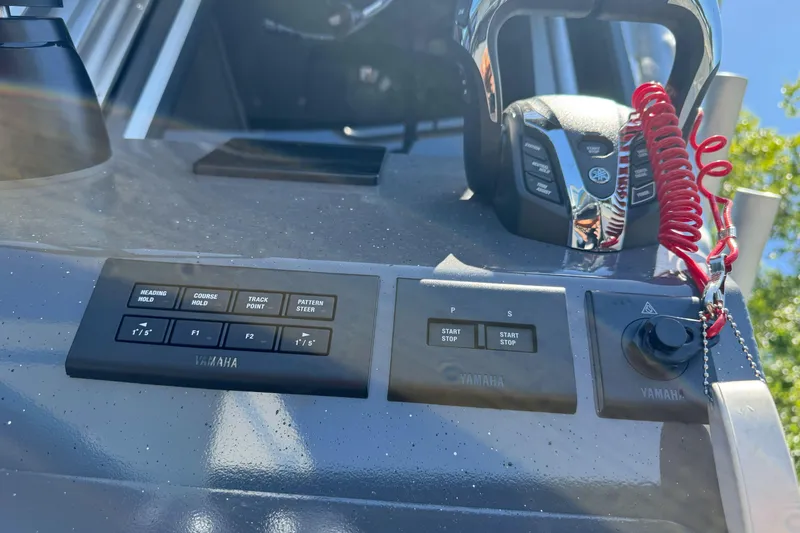 Slide: The Image of Control panel of 2026 Duckworth 28 Offshore boat with Yamaha controls and red safety cord. - 15