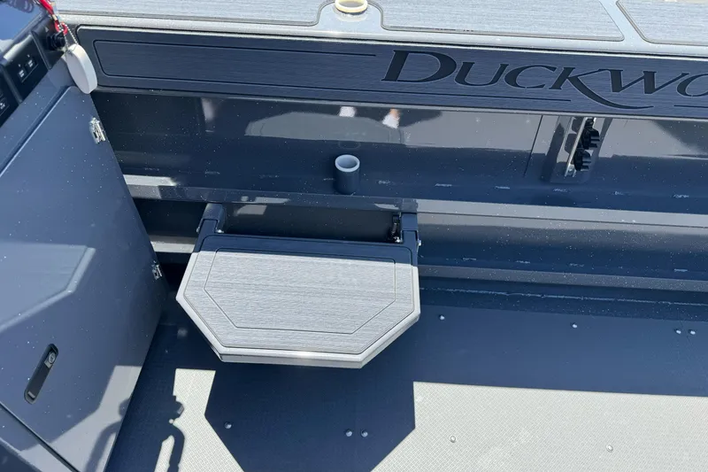Slide: The Image of 2026 Duckworth 28 Offshore boat interior with foldable seat and storage compartment. - 19