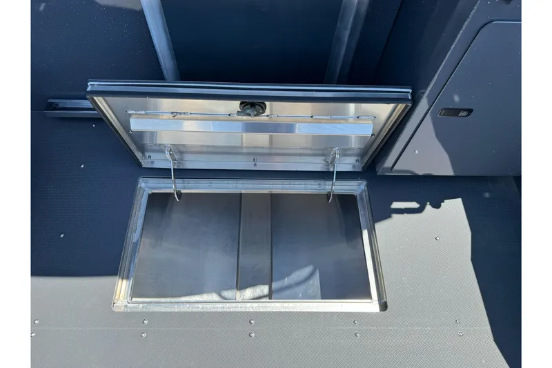 Slide: The Image of Open storage compartment on 2026 Duckworth 28 Offshore boat deck. - 24