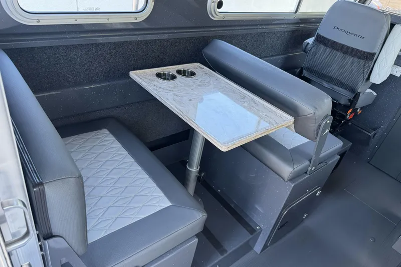 Slide: The Image of Interior of 2026 Duckworth 28 Offshore boat with seating and table setup. - 26