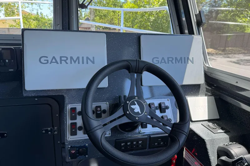 Slide: The Image of Steering wheel and Garmin displays in 2026 Duckworth 28 Offshore boat cockpit. - 32