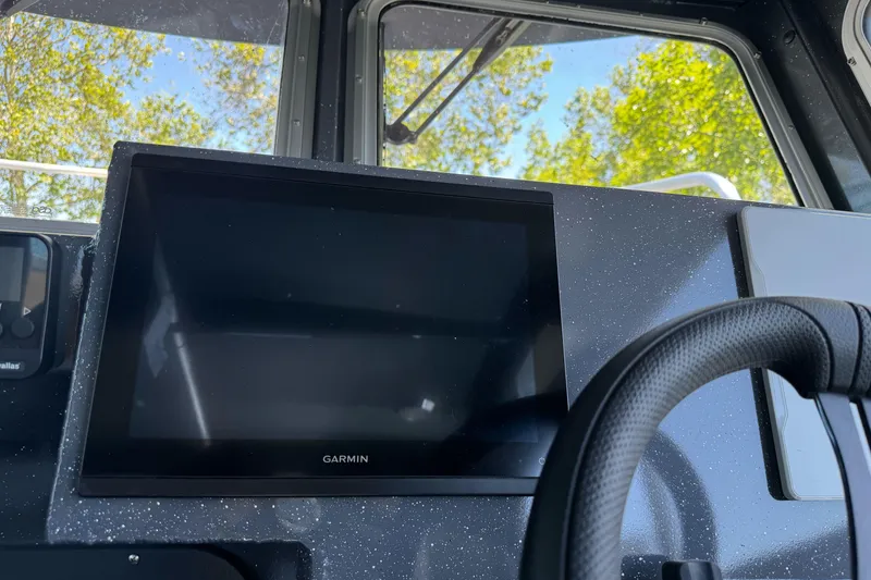 Slide: The Image of Garmin display on 2026 Duckworth 28 Offshore boat dashboard with steering wheel. - 34