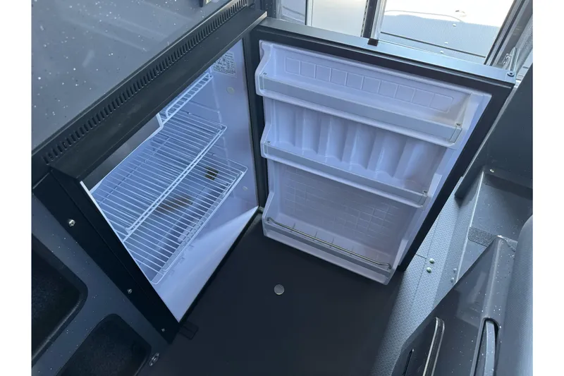 Slide: The Image of Open refrigerator inside 2026 Duckworth 28 Offshore boat, showcasing interior shelves. - 39