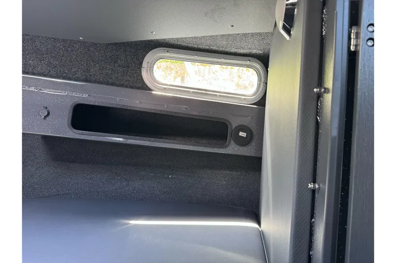 Slide: The Image of Interior cabin view of 2026 Duckworth 28 Offshore boat, featuring a window and storage compartment. - 46