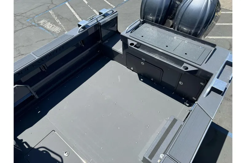 Slide: The Image of 2026 Duckworth 28 Offshore boat deck with storage compartments and dual engines. - 55