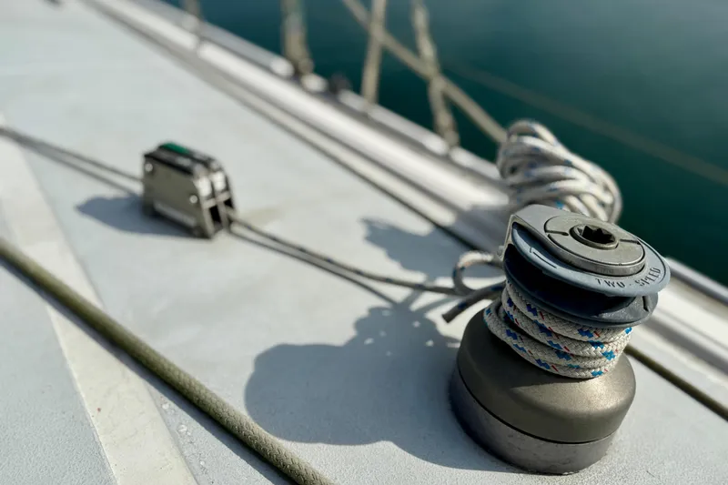 Slide: The Image of Winch and rope on 1985 MacGregor 65 sailboat deck, close-up view. - 14