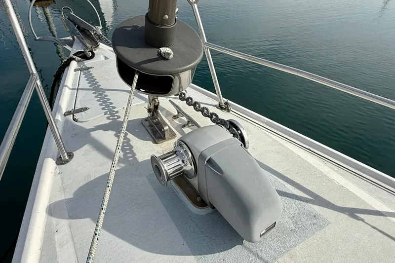 Slide: The Image of Bow of 1985 MacGregor 65 sailboat with anchor chain and winch system. - 15