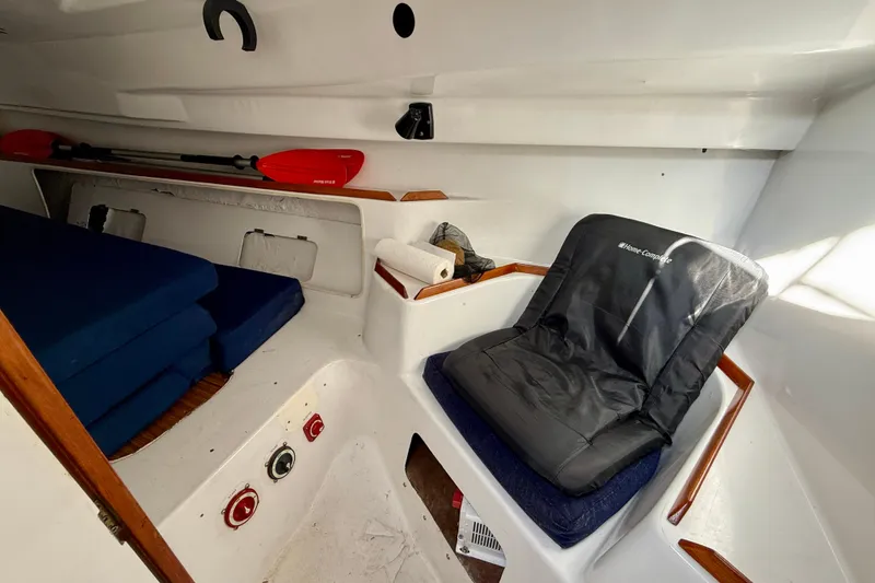 Slide: The Image of Interior of a 1985 MacGregor 65 sailboat with seating and storage. - 18