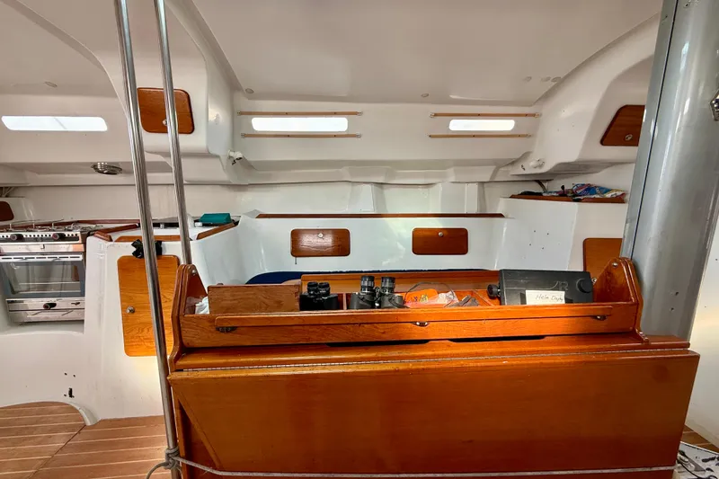 Slide: The Image of Interior of 1985 MacGregor 65 sailboat with wooden cabinetry and nautical equipment. - 24