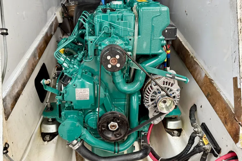 Slide: The Image of Engine of a 1985 MacGregor 65 sailboat, showcasing detailed mechanical components. - 34