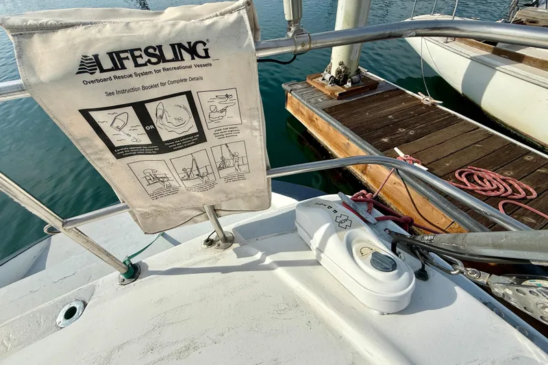 Slide: The Image of Sailboat deck with Lifesling rescue system, MacGregor 65, 1985 model, docked at marina. - 7