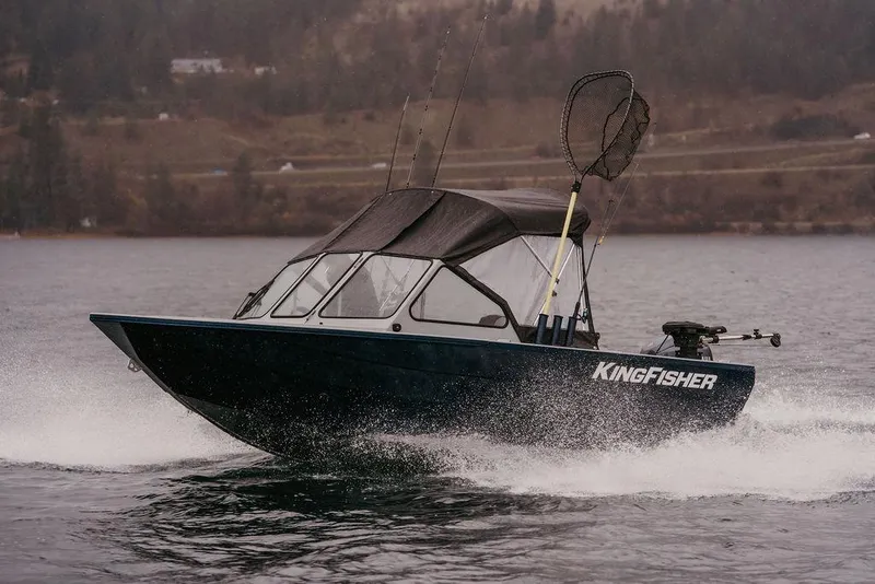 The Image of 2026 KingFisher 1625 Falcon boat cruising on a scenic lake. - 0