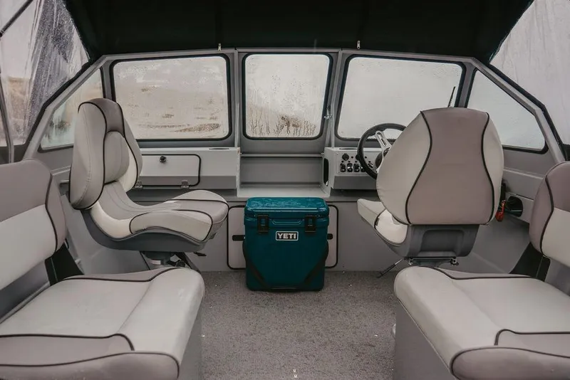 Slide: The Image of Interior of 2026 KingFisher 1625 Falcon boat with seating and Yeti cooler. - 2