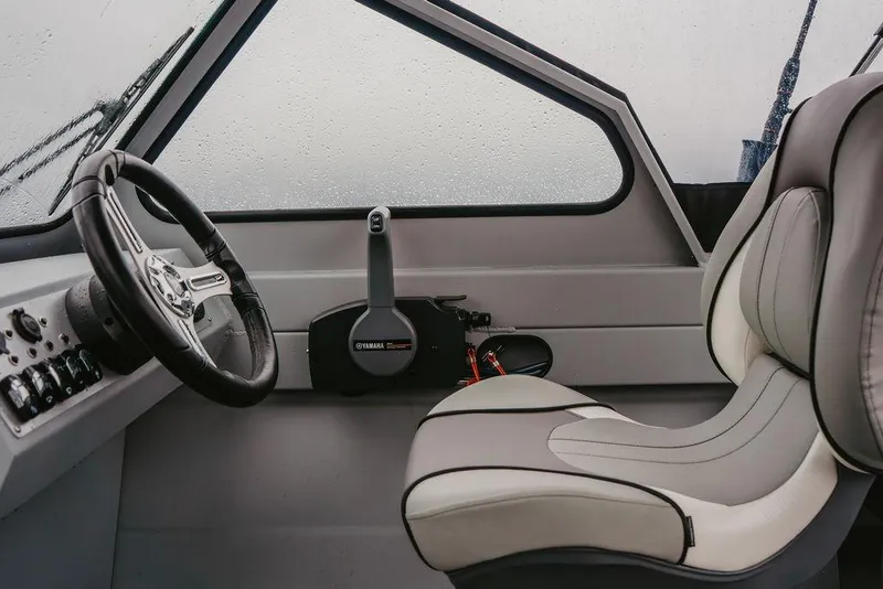 Slide: The Image of Interior of 2026 KingFisher 1625 Falcon boat with steering wheel and seat. - 8