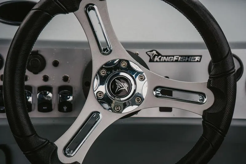 Slide: The Image of Steering wheel of 2026 KingFisher 1625 Falcon boat, featuring sleek design and logo. - 10