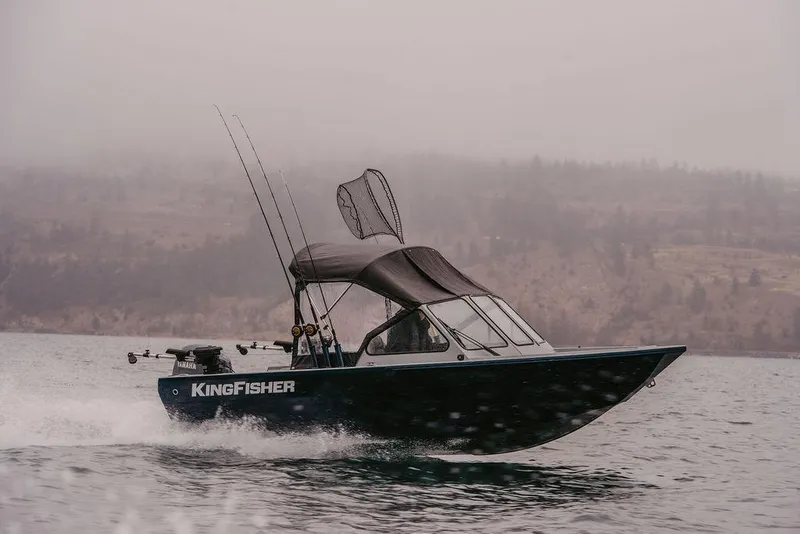 Slide: The Image of 2026 KingFisher 1625 Falcon boat cruising on a misty lake with fishing gear. - 12