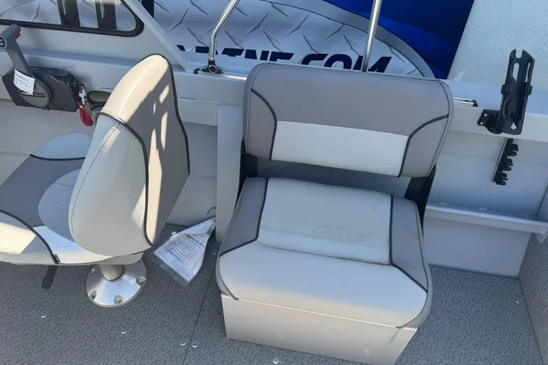 Slide: The Image of Interior of 2026 KingFisher 16 Falcon boat with gray seating and control panel. - 15