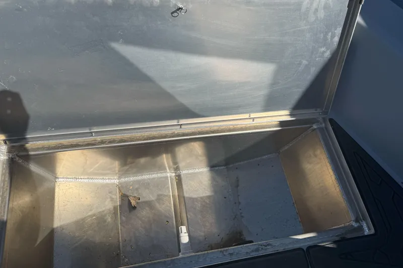 Slide: The Image of Open storage compartment in a 2026 KingFisher 16 Falcon boat, showing interior details. - 17