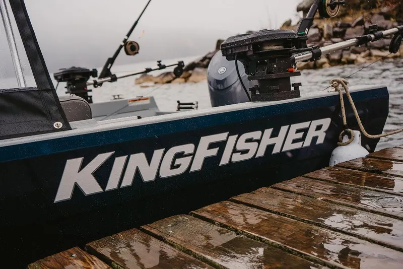 Slide: The Image of 2026 KingFisher 1625 Falcon boat docked on a wet wooden pier. - 6