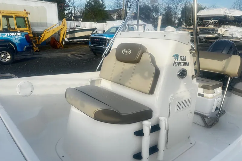 Slide: The Image of 2022 Key West 1720 Center Console boat with seating and storage, parked outdoors. - 7