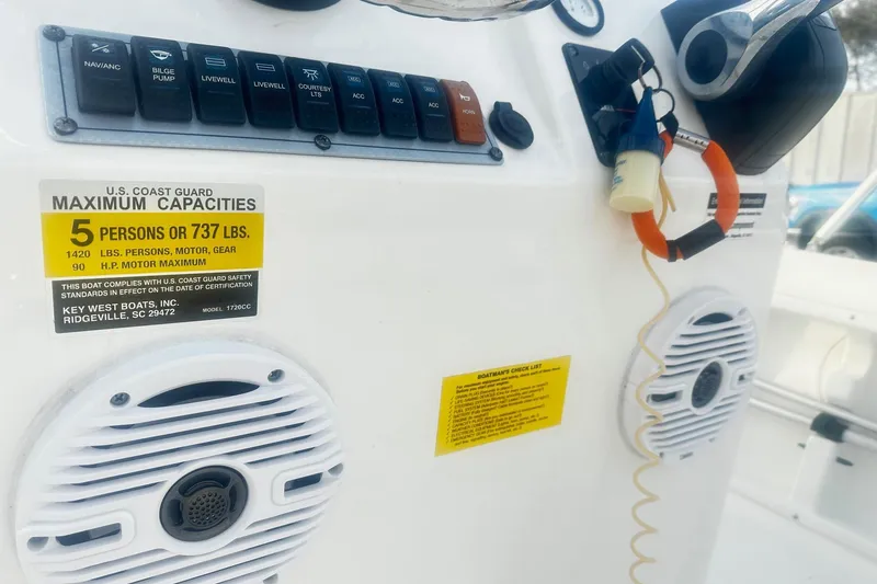 Slide: The Image of Control panel of a 2022 Key West 1720 Center Console boat with capacity details. - 9