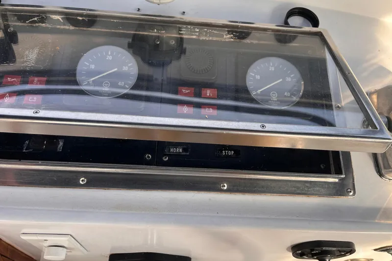Slide: The Image of Control panel of a 1986 Jefferson 42 SE Sundeck Motor Yacht with gauges and switches. - 10