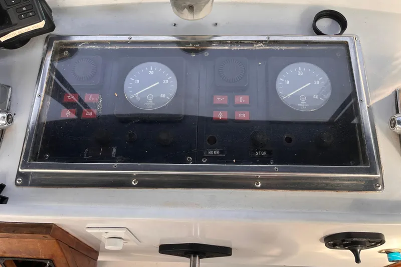 Slide: The Image of Control panel of a 1986 Jefferson 42 SE Sundeck Motor Yacht with gauges and switches. - 11