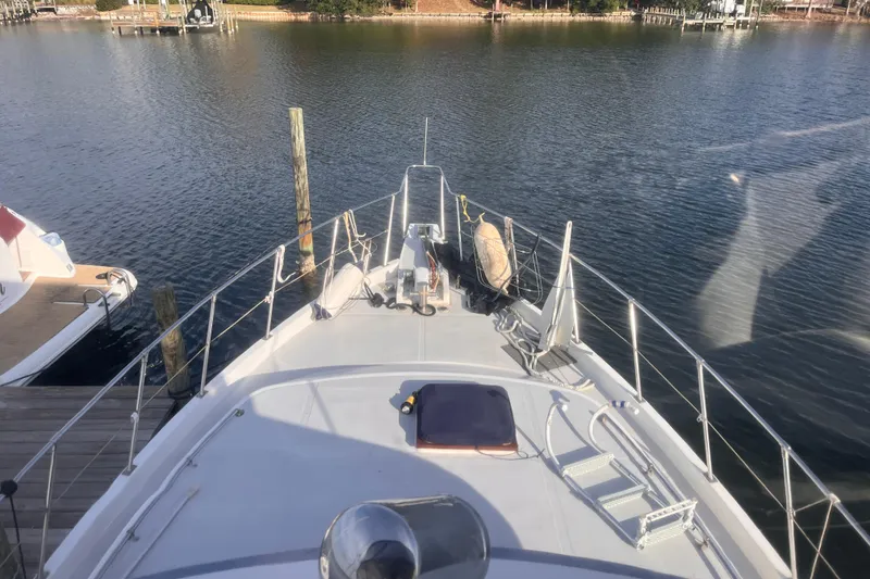 Slide: The Image of 1986 Jefferson 42 SE Sundeck Motor Yacht docked on calm water. - 12