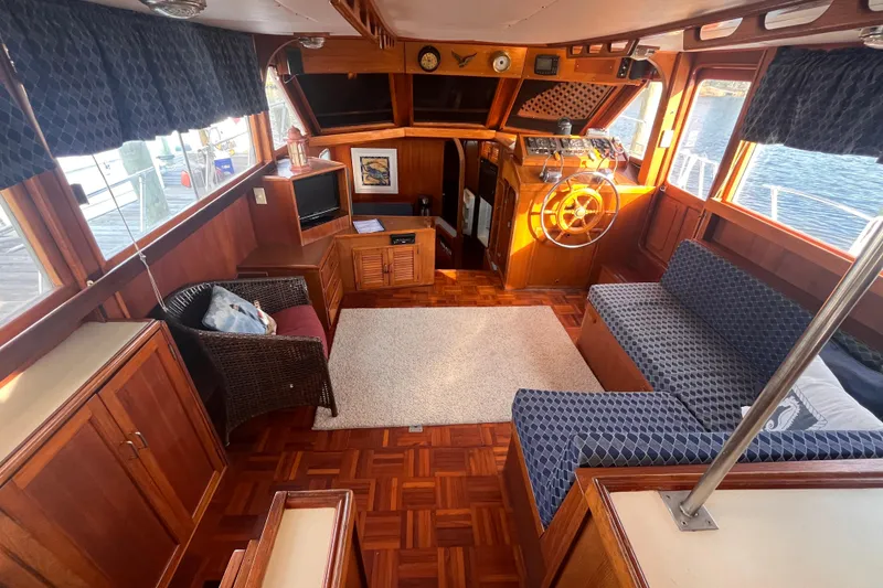 Slide: The Image of Interior of 1986 Jefferson 42 SE Sundeck Motor Yacht with wood finish and seating area. - 18