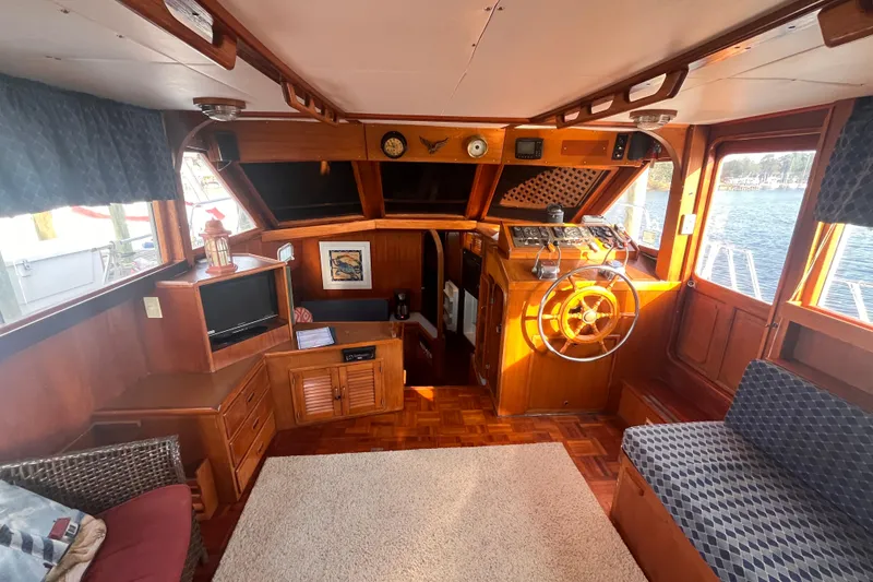 Slide: The Image of Interior of 1986 Jefferson 42 SE Sundeck Motor Yacht with wooden helm and seating area. - 19