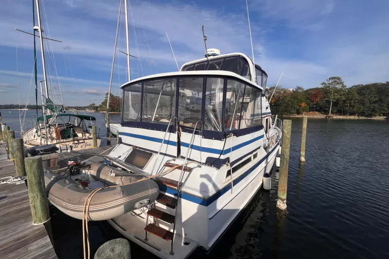 Slide: The Image of 1986 Jefferson 42 SE Sundeck Motor Yacht docked at marina. - 2