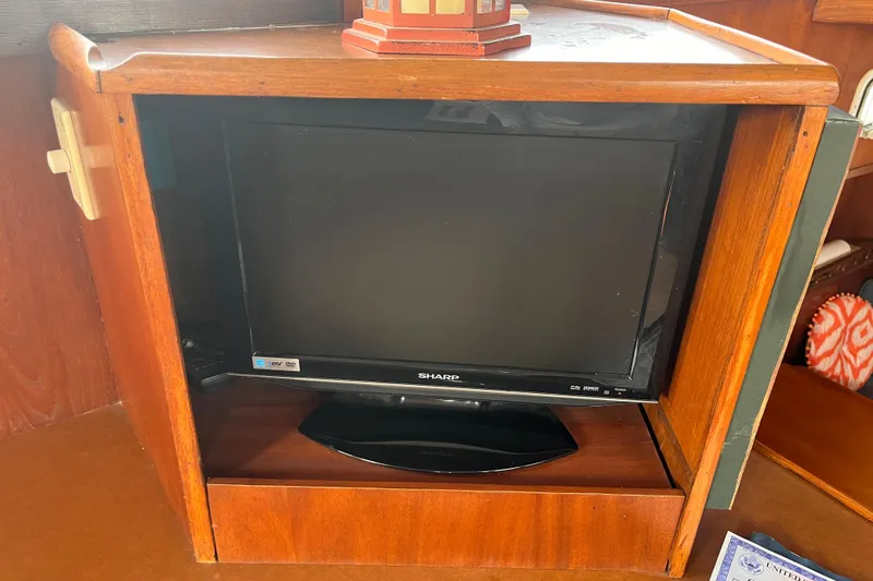 Slide: The Image of Sharp TV in wooden cabinet on 1986 Jefferson 42 SE Sundeck Motor Yacht. - 20